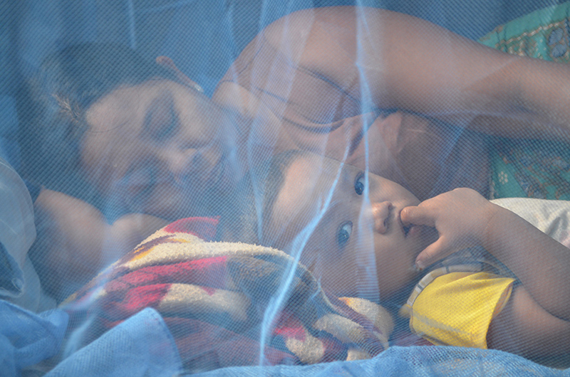 Mother and child under net, Kyun Su township, Sept 2013 (source Malaria Consortium)