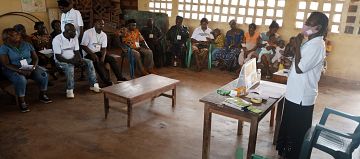 Community volunteer facilitates a community dialogue in Cameroon